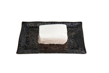 Thai pudding with coconut topping in black plate Isolated on a white background. Clipping Path