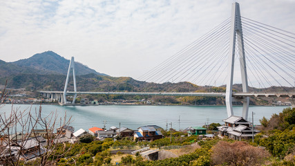 Naklejka premium Ikuchi Bridge, which connects Innoshima Island with Ikuchi Island, is the second bridge to cross while on the Shimanami Kaido cycling tour starting from Onomichi and ending at Imabari.