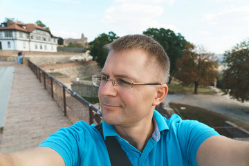 man in blue tshirt making selfie