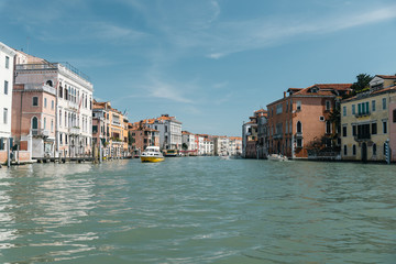 Fototapeta na wymiar Gondola passing by multicolored buildings