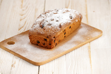 Delicious homemade cake with raisins on a light wooden background. close-up. rustic. copy space.