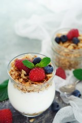Healthy Breakfast Granola Yyogurt Parfait with fresh fruits and berries, selective focus