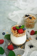 Healthy Breakfast Granola Yyogurt Parfait with fresh fruits and berries, selective focus
