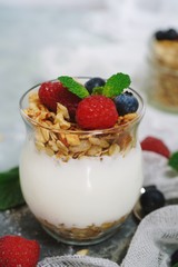 Healthy Breakfast Granola Yyogurt Parfait with fresh fruits and berries, selective focus