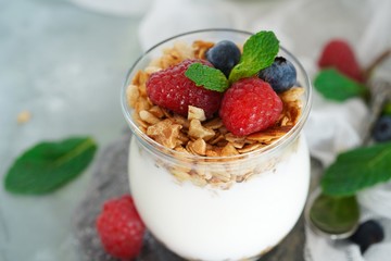 Healthy Breakfast Granola Yyogurt Parfait with fresh fruits and berries, selective focus