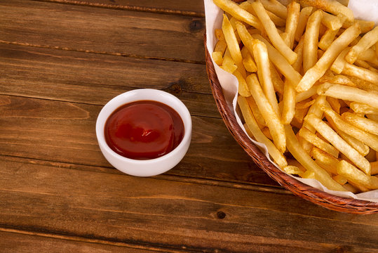 French Fries In A Basket On Wooden Table. Fast Food Restaurant Concept. Directly Above.