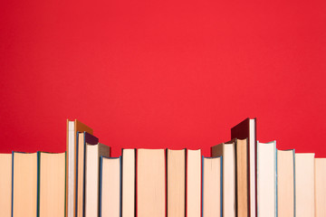 Obraz premium Row of book on a red background