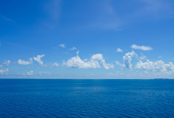Cruising on the ocean on a beautiful cloudy blue sky day.