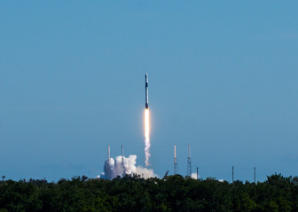 Rocket launch on a clear blue sky cloudless day.