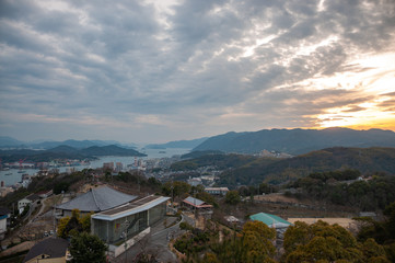 Panoramic, scenic view of Onomichi City and the Seto Inland Sea during sunset as seen from the Senkoji Park Observatory which is located on the summit of Mt. Senkoji in Hiroshima Prefecture in Japan.