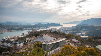 Panoramic, scenic view of Onomichi City and the Seto Inland Sea during sunset as seen from the Senkoji Park Observatory which is located on the summit of Mt. Senkoji in Hiroshima Prefecture in Japan.