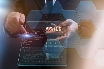 The concept of business, technology, the Internet and the network. A young entrepreneur working on a virtual screen of the future and sees the inscription: Agile