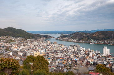 Fototapeta na wymiar Panoramic, scenic view of Onomichi City and the Seto Inland Sea as seen while climbing the countless steps towards the summit of Mt. Senkoji in Hiroshima Prefecture in Japan.