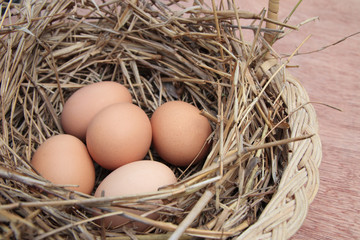 Eggs in basket with wooden background