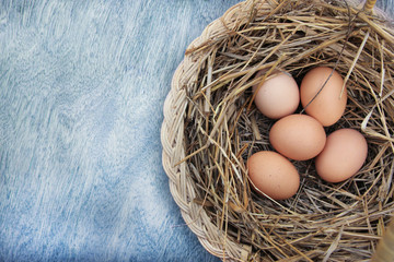 Eggs in basket with wood vintage background