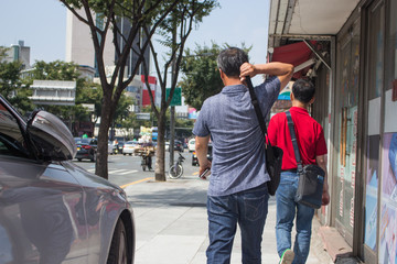 Obraz na płótnie Canvas Korean pedestrians walking on sidewalk in Daegu, Korea