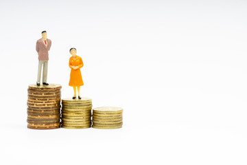 Miniature people standing on coins with white background. Business and Lifestyle concepts.