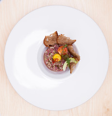 Marbled beef tartare on a white plate