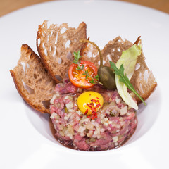 Marbled beef tartare on a white plate