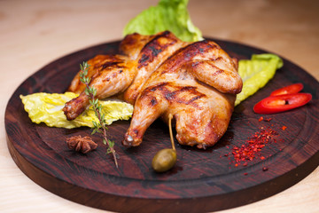 Roast chicken and leaf lettuce on a wooden board