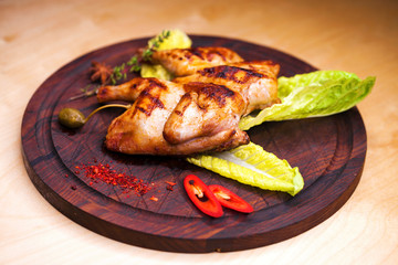 Roast chicken and leaf lettuce on a wooden board