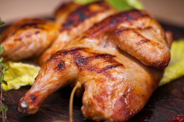 Roast chicken and leaf lettuce on a wooden board