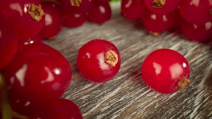 Super close macro of a redcurrants on a wooden table.