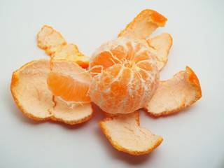 Mandarin is cleared from the skin. Fruit on white background.