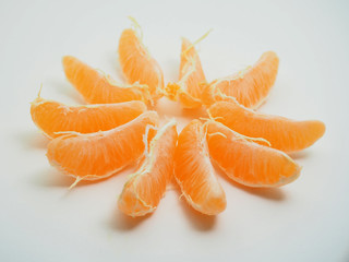 Mandarin is cleared from the skin. Fruit on white background.