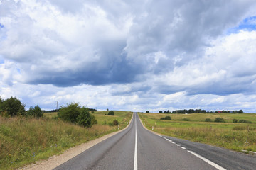 Dark clouds above the road.