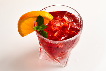 Red fresh drink with ice, grapefruit and mint isolated on white. Space for text or design.