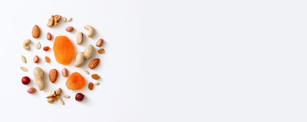 Naklejka na ściany i meble Assorted nuts on a white table. Hazelnuts, cashews, peanuts, walnuts, almonds.