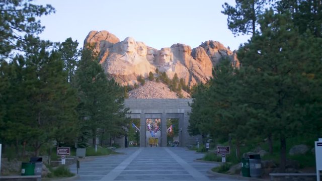 Cinematic tilt up while walking through entrance of mount rushmore