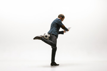 Businessman with tablet and football ball in office. Soccer freestyle. Concept of balance and...