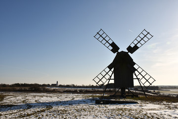 Old windmill silhouette in winter season