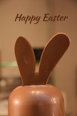 Ears of chocolate easter bunny with happy easter text.