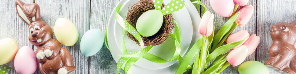 Easter holiday table setting with rabbits and eggs