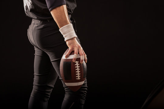 Cropped Image Of Sportsman Holding American Football Ball