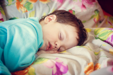 Obraz na płótnie Canvas the boy is sleeping. little baby is sleeping sweet sleep baby. boy in a blue fleece suit