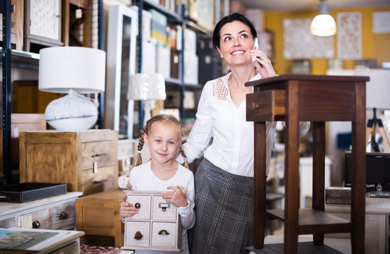 Woman with girl in furniture store
