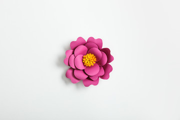 top view of pink paper flower on grey background