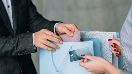 Shopping time. Family leisure and lifestyle. Man and woman with credit card and bags variety.