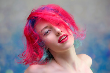 High fashion model woman with multi-colored hair posing in the studio, portrait of a beautiful sexy girl with a fashionable makeup