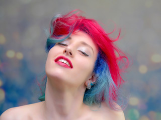 High fashion model woman with multi-colored hair posing in the studio, portrait of a beautiful sexy girl with a fashionable makeup