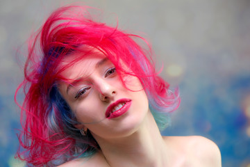 High fashion model woman with multi-colored hair posing in the studio, portrait of a beautiful sexy girl with a fashionable makeup