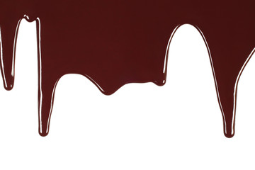 Melted chocolate dripping on white background