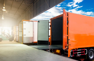 Cargo Container Trucks Parked Loading at Dock Warehouse. Shipment. Packaging Boxes Supply Chain. Distribution Warehouse Shipping . Lorry. Cargo Freight Truck Transport Logistics.	