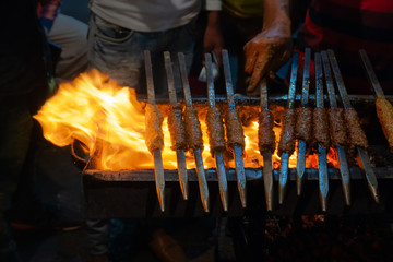 Chicken seekh kababs are being prepared road side