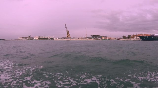 Time Lapse from a water bus in Venice Italy with a beautiful magenta sky. The boat is driving through the Canal Grande.