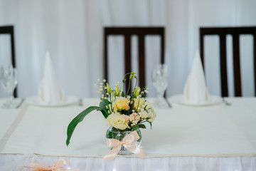 Bouquet of flowers live on a table with white texture.